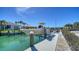 Boat on a lift at a private dock with views of the waterfront canal and homes at 560 Schooner Ln, Longboat Key, FL 34228