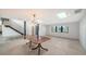 Dining room featuring modern chandelier, staircase, and a large window, creating a bright and inviting space at 560 Schooner Ln, Longboat Key, FL 34228