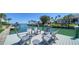 Waterfront dock with gray Adirondack chairs overlooking the beautiful canal and neighborhood at 560 Schooner Ln, Longboat Key, FL 34228