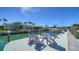Waterfront dock with gray Adirondack chairs overlooking the beautiful canal and neighborhood at 560 Schooner Ln, Longboat Key, FL 34228