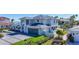 Modern two-story home with a sleek design, glass garage door, and well-manicured lawn at 560 Schooner Ln, Longboat Key, FL 34228