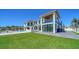 Stunning modern home with a pool, lush lawn, and an outdoor spiral staircase at 560 Schooner Ln, Longboat Key, FL 34228