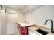 Convenient laundry room with modern washer, dryer, sink, and ample counter space at 560 Schooner Ln, Longboat Key, FL 34228
