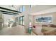 Open-concept living room featuring high ceilings, floor-to-ceiling windows, and a modern design, enhancing natural light at 560 Schooner Ln, Longboat Key, FL 34228