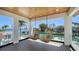 Covered patio with hanging chairs providing scenic water views, perfect for relaxing and enjoying the outdoors at 560 Schooner Ln, Longboat Key, FL 34228