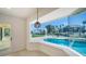 Bright sunroom with expansive bay window view of the pool and canal, creating a serene indoor-outdoor living experience at 560 Schooner Ln, Longboat Key, FL 34228