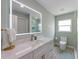 Stylish bathroom features modern vanity with lit mirror, designer fixtures, and glass enclosed shower at 611 Dundee Ln, Holmes Beach, FL 34217
