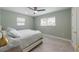 Cozy bedroom with tile floors, ceiling fan, and comfortable bed for restful nights at 611 Dundee Ln, Holmes Beach, FL 34217