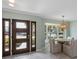 Cozy dining area featuring a front door, stylish pendant lighting, and an inviting view at 611 Dundee Ln, Holmes Beach, FL 34217