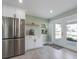 Bright kitchen area featuring stainless steel refrigerator and access to the backyard at 611 Dundee Ln, Holmes Beach, FL 34217