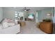 Bright living room boasts tile floors, ceiling fan, and modern furnishings for comfortable living at 611 Dundee Ln, Holmes Beach, FL 34217