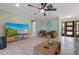Open concept living room featuring tile floors, ceiling fan, and access to other rooms in the house at 611 Dundee Ln, Holmes Beach, FL 34217
