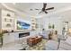 Beautiful living room with fireplace, built-in shelving, ceiling fan, and comfortable seating at 6115 Cessna Run, Bradenton, FL 34211