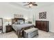 Comfortable main bedroom with neutral tones, ceiling fan, and decorative accents at 6115 Cessna Run, Bradenton, FL 34211