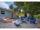 Private backyard featuring a fire pit with chairs, lounge chairs and mature landscaping at 617 26Th W St, Bradenton, FL 34205
