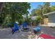 Relaxing backyard area complete with blue chairs surrounding a charming stone fire pit at 617 26Th W St, Bradenton, FL 34205