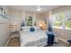 Comfortable bedroom with coastal decor, ample natural light, and a ceiling fan for added comfort at 617 26Th W St, Bradenton, FL 34205