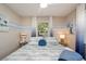 Calm bedroom featuring coastal decor, side tables with lamps, and a ceiling fan at 617 26Th W St, Bradenton, FL 34205