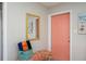 Stylish entryway features colorful accents, bright light and a coral door at 617 26Th W St, Bradenton, FL 34205