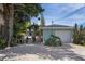 Exterior features garage, tropical landscaping, and outdoor seating in a private setting at 617 26Th W St, Bradenton, FL 34205