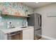Well-equipped kitchen with stainless steel appliances, light backsplash, and open shelving at 617 26Th W St, Bradenton, FL 34205