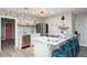 Modern kitchen features stainless steel appliances, open shelving and stylish seating at 617 26Th W St, Bradenton, FL 34205