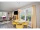 Bright living room featuring large windows and a yellow dining set adjacent to a cozy seating area at 617 26Th W St, Bradenton, FL 34205