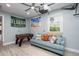 Inviting recreation room with a foosball table, comfortable couch, and a ceiling fan for added comfort at 617 26Th W St, Bradenton, FL 34205