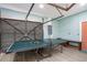 Spacious recreation room features a ping pong table and an industrial door for easy access at 617 26Th W St, Bradenton, FL 34205