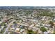 Expansive aerial view of a residential neighborhood with many homes, a serene pond, and lush green spaces at 6637 Bowline Dr, Sarasota, FL 34231