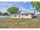 Spacious backyard featuring a well-maintained lawn and mature trees at 6637 Bowline Dr, Sarasota, FL 34231