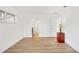 Bright bedroom with laminate flooring, neutral walls, and a red nightstand at 6637 Bowline Dr, Sarasota, FL 34231