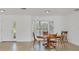 Sunlit dining area with a round wooden table, chairs, and a large window at 6637 Bowline Dr, Sarasota, FL 34231