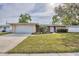 Charming single-story home with brick accents, manicured landscaping, and a two-car garage at 6637 Bowline Dr, Sarasota, FL 34231