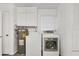 Well-equipped laundry area with a washer, dryer, and extra cabinet storage at 6637 Bowline Dr, Sarasota, FL 34231