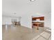 Open living space features bright white walls, tile floors, and a breakfast bar open to the kitchen at 6637 Bowline Dr, Sarasota, FL 34231