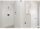 Modern tiled shower with a built-in niche and updated fixtures in a renovated bathroom at 6637 Bowline Dr, Sarasota, FL 34231