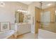 Bathroom with walk-in shower, tiled walls, large mirror, and double vanity with appealing cabinets at 7137 Orchid Island Pl, Bradenton, FL 34202