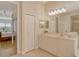 Bathroom featuring vanity with drawers and cabinets, and a doorway to a bedroom with outdoor view at 7137 Orchid Island Pl, Bradenton, FL 34202