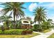 Landscaped community entrance with lush greenery, vibrant flowers, and a charming covered entryway at 7137 Orchid Island Pl, Bradenton, FL 34202