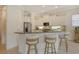 Bright eat-in kitchen with white cabinets, granite counters, breakfast bar, and stainless steel appliances at 7137 Orchid Island Pl, Bradenton, FL 34202