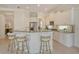 Bright kitchen featuring white cabinets, granite counters, breakfast bar, and stainless steel appliances at 7137 Orchid Island Pl, Bradenton, FL 34202