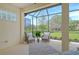 Screened-in lanai featuring outdoor furniture, tiled floor, and nice view of backyard and landscape at 7137 Orchid Island Pl, Bradenton, FL 34202