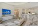 Inviting living room featuring a tray ceiling, a TV, and comfortable seating arrangements at 7137 Orchid Island Pl, Bradenton, FL 34202