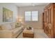 Inviting living room featuring light walls, hardwood floors, sectional sofa, and a large storage cabinet at 7137 Orchid Island Pl, Bradenton, FL 34202