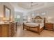 Spacious main bedroom with wood floors, decorative tray ceiling, and light neutral color palette at 7137 Orchid Island Pl, Bradenton, FL 34202