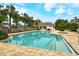 Community pool featuring a spacious deck area, comfortable seating, and well-maintained landscaping for relaxing and socializing at 7137 Orchid Island Pl, Bradenton, FL 34202