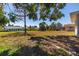 Expansive backyard with green space and lush trees surrounding the perimeter at 7307 14Th W Ave, Bradenton, FL 34209