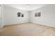 Light filled bedroom with two windows and light wood flooring at 7307 14Th W Ave, Bradenton, FL 34209