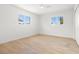 Bright bedroom with light wood flooring, two windows and a ceiling fan at 7307 14Th W Ave, Bradenton, FL 34209